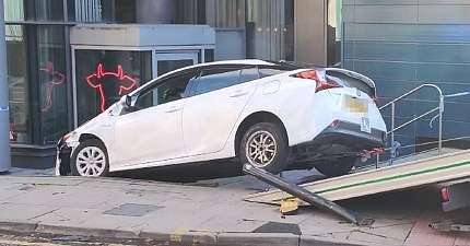 PRIVATE HIRE VEHICLE FLIPS DOWN STEPS OUTSIDE MANCHESTER CITY CENTRE HOTEL